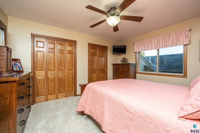 3121 S Dubuque Ave, Sioux Falls, SD 57110 - bedroom featuring two closets, light colored carpet, and ceiling fan