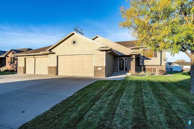 3121 S Dubuque Ave, Sioux Falls, SD 57110 - view of front of home with brick siding, an attached garage, a front lawn, and driveway