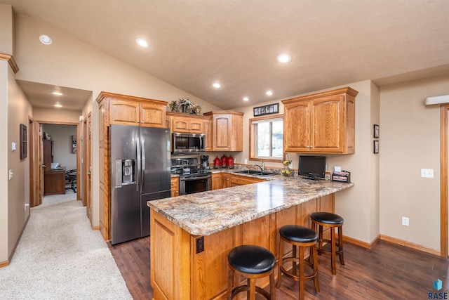3121 S Dubuque Ave, Sioux Falls, SD 57110 - kitchen featuring stainless steel appliances, a peninsula, dark wood-type flooring, recessed lighting, and light stone countertops