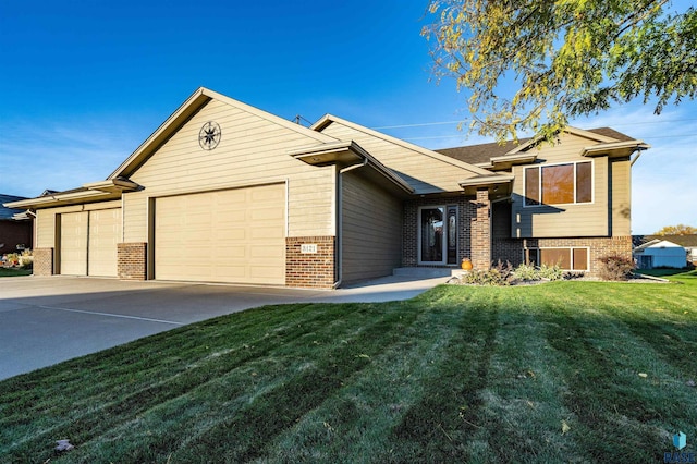 3121 S Dubuque Ave, Sioux Falls, SD 57110 - view of front of house featuring brick siding, an attached garage, concrete driveway, and a front yard