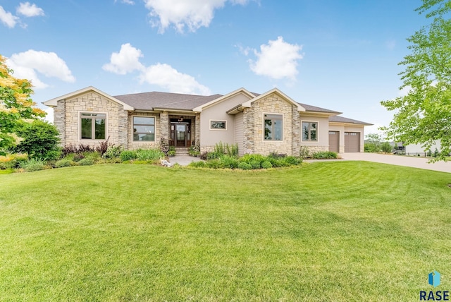 512 E 77th St, Sioux Falls, SD 57108 - prairie-style home with stone siding, concrete driveway, a front yard, and a garage