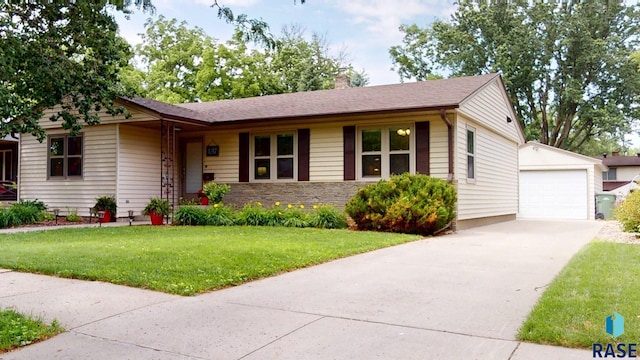 1617 1st St, Brookings, SD 57006 - single story home with an outbuilding, a chimney, a front lawn, concrete driveway, and a detached garage