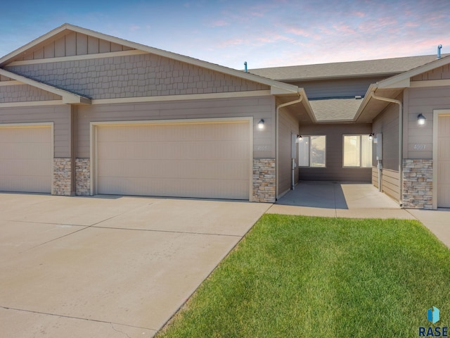 4005 S Grand Slam Ave, Sioux Falls, SD 57110 - view of front of property featuring stone siding, an attached garage, and concrete driveway