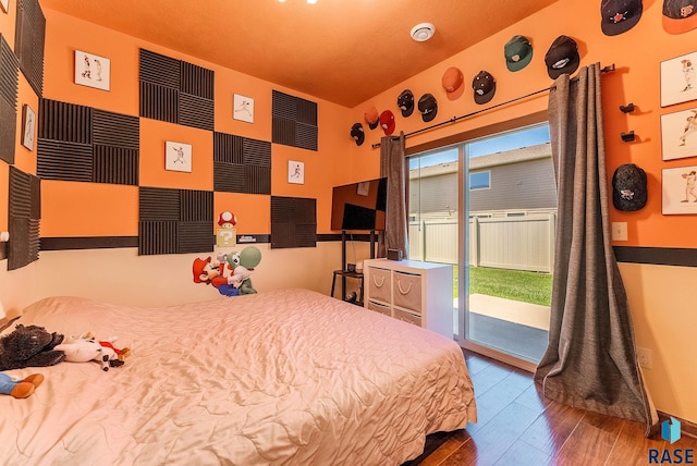 4005 S Grand Slam Ave, Sioux Falls, SD 57110 - bedroom featuring access to exterior, wood finished floors, and multiple windows
