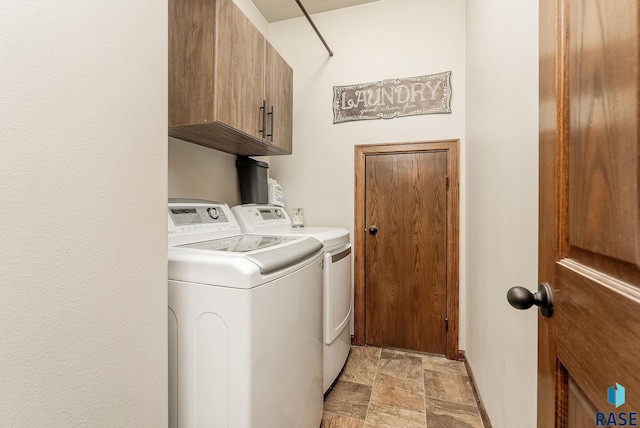 4005 S Grand Slam Ave, Sioux Falls, SD 57110 - laundry area featuring cabinet space, independent washer and dryer, and stone finish floors