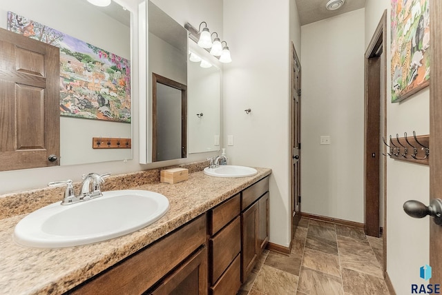 4005 S Grand Slam Ave, Sioux Falls, SD 57110 - bathroom featuring double vanity and stone finish flooring