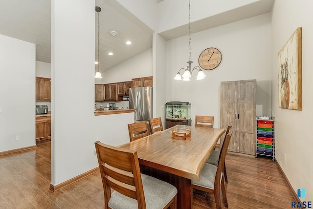 4005 S Grand Slam Ave, Sioux Falls, SD 57110 - dining room featuring high vaulted ceiling, wood finished floors, a chandelier, and recessed lighting