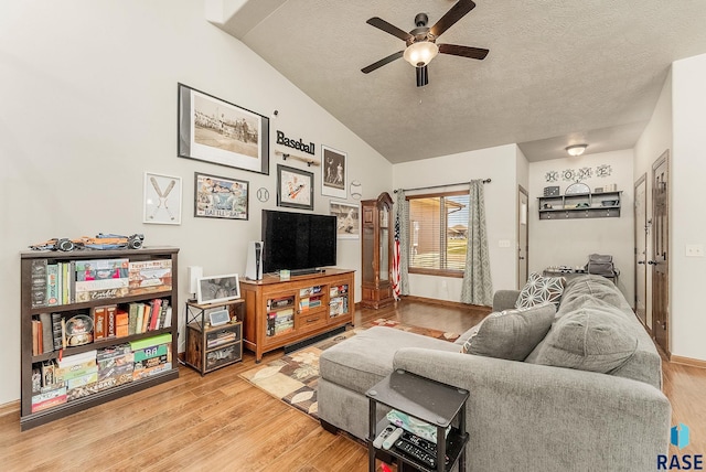 4005 S Grand Slam Ave, Sioux Falls, SD 57110 - living room with ceiling fan, vaulted ceiling, a textured ceiling, and wood finished floors