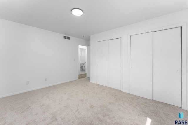 409 S 8th Ave, Brandon, SD 57005 - unfurnished bedroom with multiple closets and carpet