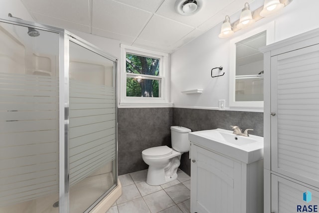 409 S 8th Ave, Brandon, SD 57005 - full bathroom featuring tile patterned flooring, vanity, a wainscoted wall, and a shower stall