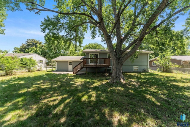 409 S 8th Ave, Brandon, SD 57005 - rear view of property featuring a wooden deck, stairs, and a fenced backyard