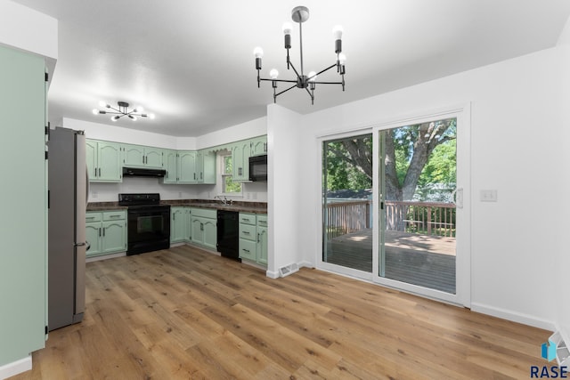 409 S 8th Ave, Brandon, SD 57005 - kitchen with black appliances, a chandelier, green cabinets, and under cabinet range hood