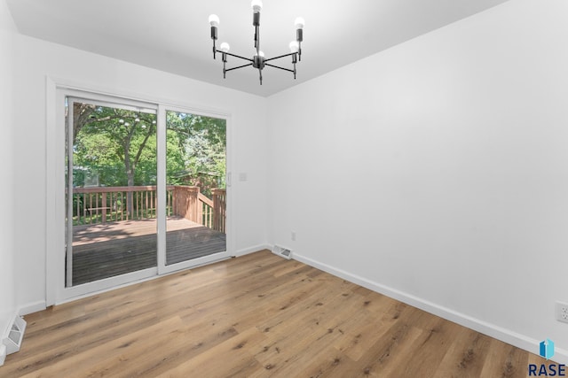 409 S 8th Ave, Brandon, SD 57005 - unfurnished dining area featuring a chandelier and wood finished floors