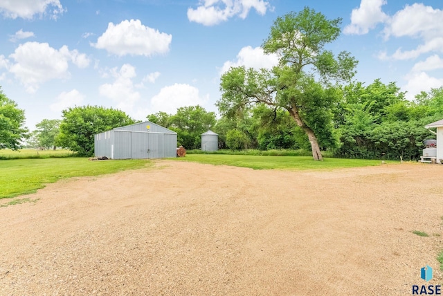 28437 462nd Ave, Davis, SD 57021 - view of green lawn featuring an outbuilding, an outdoor structure, a detached garage, and view of wooded area