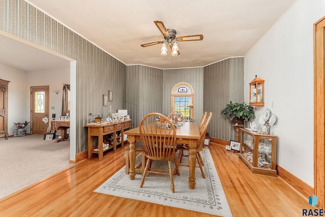28437 462nd Ave, Davis, SD 57021 - dining room with wood finished floors, wallpapered walls, a ceiling fan, plenty of natural light, and ornamental molding