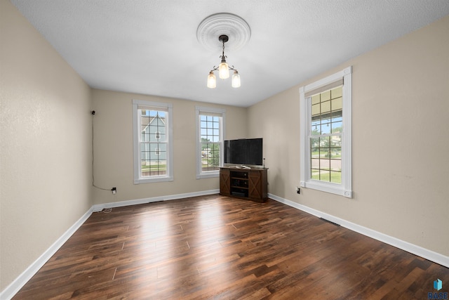 624 S 2nd Ave, Sioux Falls, SD 57104 - unfurnished living room with a chandelier and dark wood-type flooring
