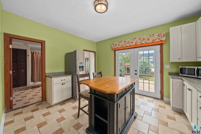 624 S 2nd Ave, Sioux Falls, SD 57104 - kitchen with appliances with stainless steel finishes, white cabinetry, and french doors
