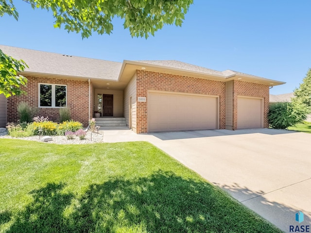 5809 S Nature Run Pl, Sioux Falls, SD 57108 - view of front of house featuring an attached garage, brick siding, concrete driveway, a front yard, and a shingled roof