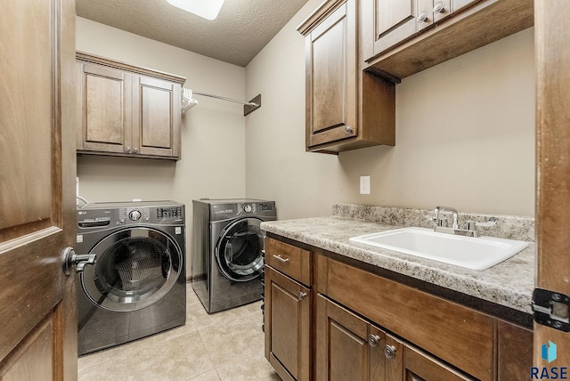 5809 S Nature Run Pl, Sioux Falls, SD 57108 - laundry area featuring cabinet space, washer and dryer, light tile patterned floors, and a textured ceiling