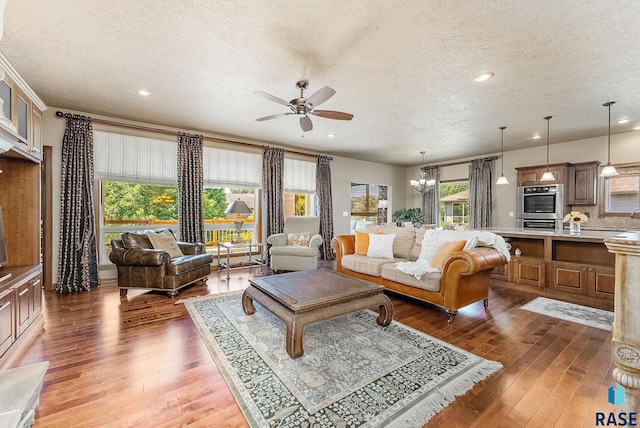 5809 S Nature Run Pl, Sioux Falls, SD 57108 - living area with a textured ceiling, ceiling fan, light wood-type flooring, recessed lighting, and a chandelier