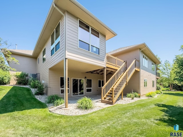 5809 S Nature Run Pl, Sioux Falls, SD 57108 - rear view of property with stairway, a patio, a yard, and a wooden deck