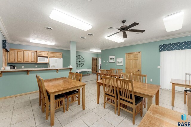 5809 S Nature Run Pl, Sioux Falls, SD 57108 - dining room with ornamental molding, light tile patterned floors, ceiling fan, and a textured ceiling