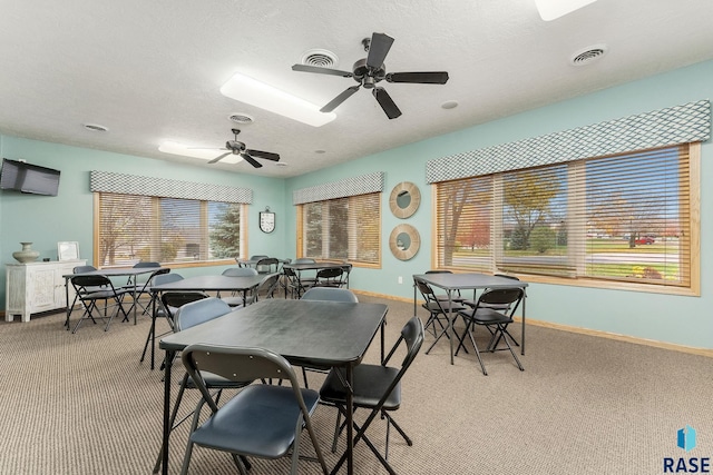 5809 S Nature Run Pl, Sioux Falls, SD 57108 - dining room with light carpet, a ceiling fan, and a textured ceiling