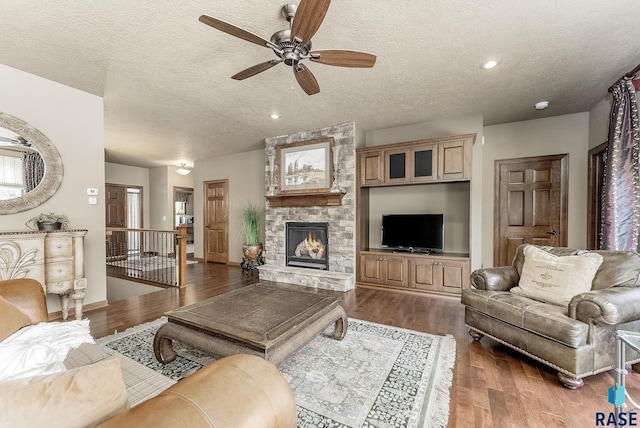 5809 S Nature Run Pl, Sioux Falls, SD 57108 - living area with ceiling fan, a textured ceiling, a fireplace, wood finished floors, and recessed lighting