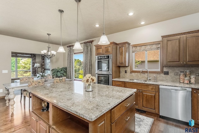 5809 S Nature Run Pl, Sioux Falls, SD 57108 - kitchen with stainless steel appliances, dark wood finished floors, open shelves, light stone countertops, and a textured ceiling