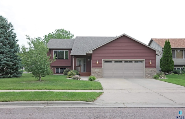 4400 E 38th St, Sioux Falls, SD 57103 - split level home featuring an attached garage, driveway, a front lawn, and brick siding