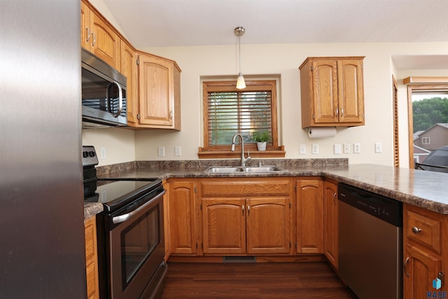4400 E 38th St, Sioux Falls, SD 57103 - kitchen featuring stainless steel appliances, dark wood finished floors, dark countertops, and pendant lighting