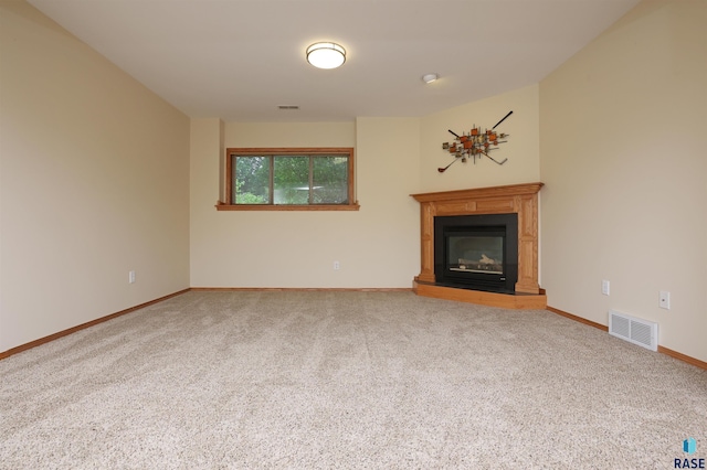 4400 E 38th St, Sioux Falls, SD 57103 - unfurnished living room with carpet floors and a glass covered fireplace
