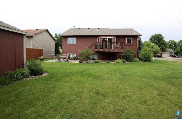 4400 E 38th St, Sioux Falls, SD 57103 - back of property featuring a wooden deck, a lawn, and a patio