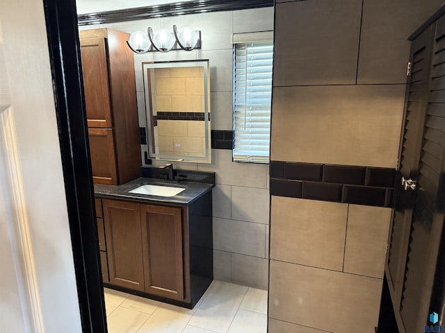27139 US Highway 81, Freeman, SD 57319 - bathroom with vanity, tile patterned flooring, tile walls, and a chandelier