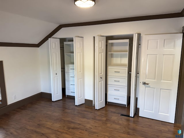 27139 US Highway 81, Freeman, SD 57319 - unfurnished bedroom featuring multiple closets, lofted ceiling, dark wood-type flooring, and crown molding