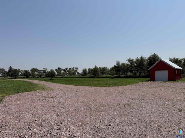 27139 US Highway 81, Freeman, SD 57319 - view of green lawn featuring a garage, driveway, and an outbuilding
