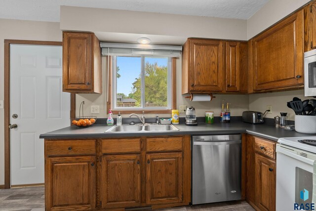 4504 S Plains Dr, Sioux Falls, SD 57106 - kitchen featuring dishwasher, white electric range oven, brown cabinetry, and dark countertops