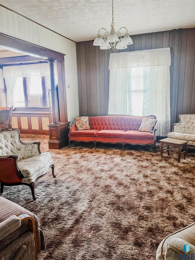 402 E 1st Ave, Beaver Creek, MN 56116 - carpeted living room featuring a chandelier and wood walls