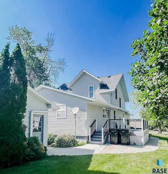 402 E 1st Ave, Beaver Creek, MN 56116 - back of property featuring a deck and a lawn