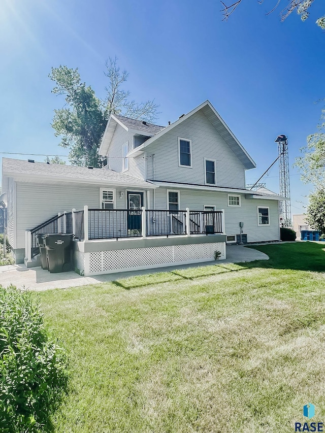 402 E 1st Ave, Beaver Creek, MN 56116 - back of house featuring a wooden deck and a lawn