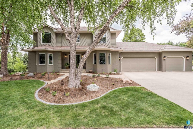 5101 S Jasmine Trl, Sioux Falls, SD 57108 - view of front of property featuring an attached garage, concrete driveway, and a front lawn