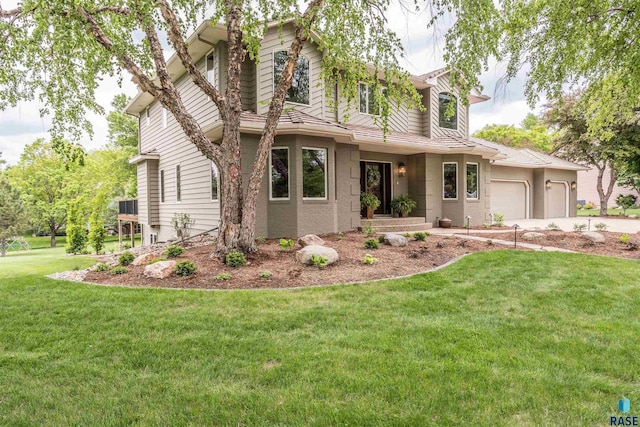 5101 S Jasmine Trl, Sioux Falls, SD 57108 - view of front facade featuring a garage, a front lawn, and concrete driveway
