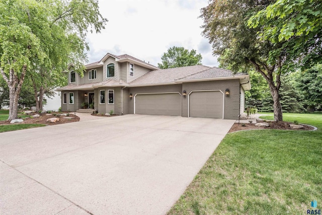 5101 S Jasmine Trl, Sioux Falls, SD 57108 - traditional-style home featuring a garage, a tile roof, concrete driveway, a front yard, and stucco siding