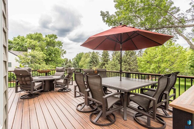 5101 S Jasmine Trl, Sioux Falls, SD 57108 - wooden deck with outdoor dining space, a fire pit, and view of scattered trees