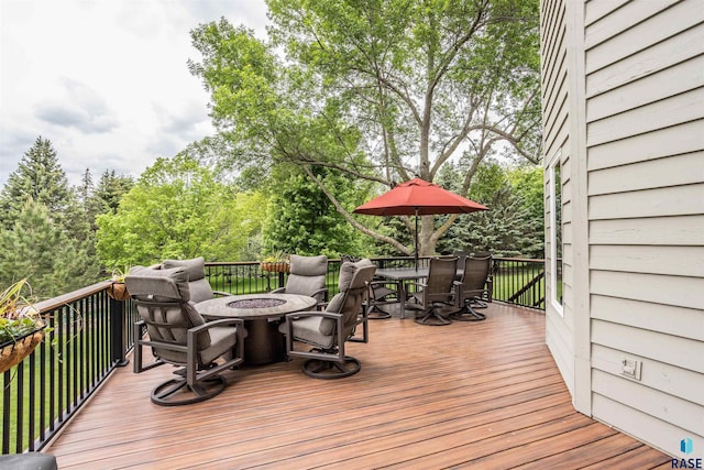 5101 S Jasmine Trl, Sioux Falls, SD 57108 - wooden terrace featuring outdoor dining area, an outdoor fire pit, and view of wooded area