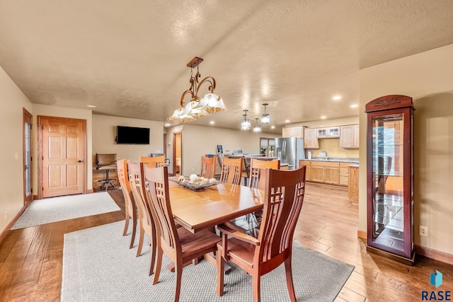 705 Railway St, Canistota, SD 57012 - dining space featuring light wood-style floors and a textured ceiling
