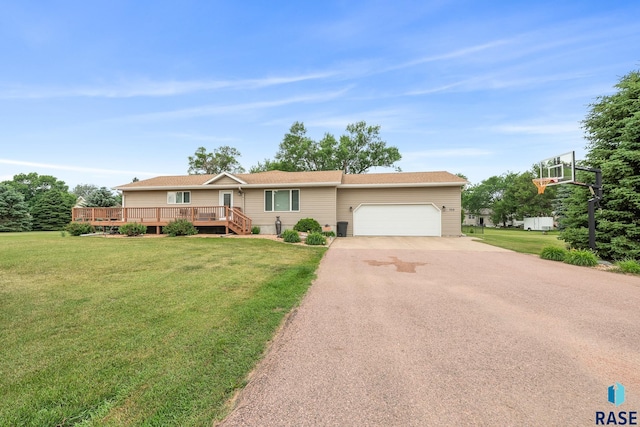 705 Railway St, Canistota, SD 57012 - single story home featuring asphalt driveway, a garage, a front lawn, and a deck