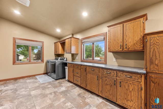 705 Railway St, Canistota, SD 57012 - washroom with cabinet space, separate washer and dryer, plenty of natural light, recessed lighting, and light stone finish flooring