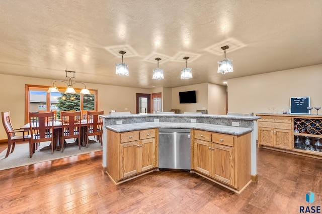 705 Railway St, Canistota, SD 57012 - kitchen featuring stainless steel dishwasher, dark wood-style flooring, pendant lighting, and a textured ceiling