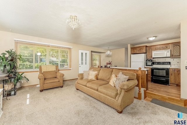 612 E 26th St, Sioux Falls, SD 57105 - living area featuring a chandelier, a textured ceiling, and light carpet